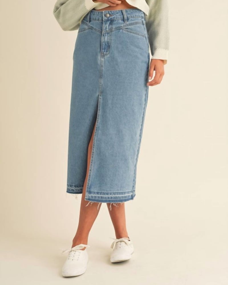 Front of a model wearing a size Large Front Slit Midi Denim Skirt in Blue in Blue by MABLE. | dia_product_style_image_id:339283